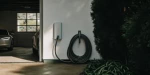 A home EV charger installation in a garage, a major factor in the final cost.