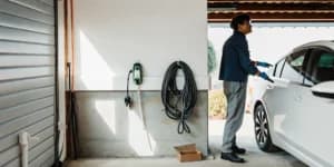 Licensed electrician installing a Level 2 EV charger in a home garage