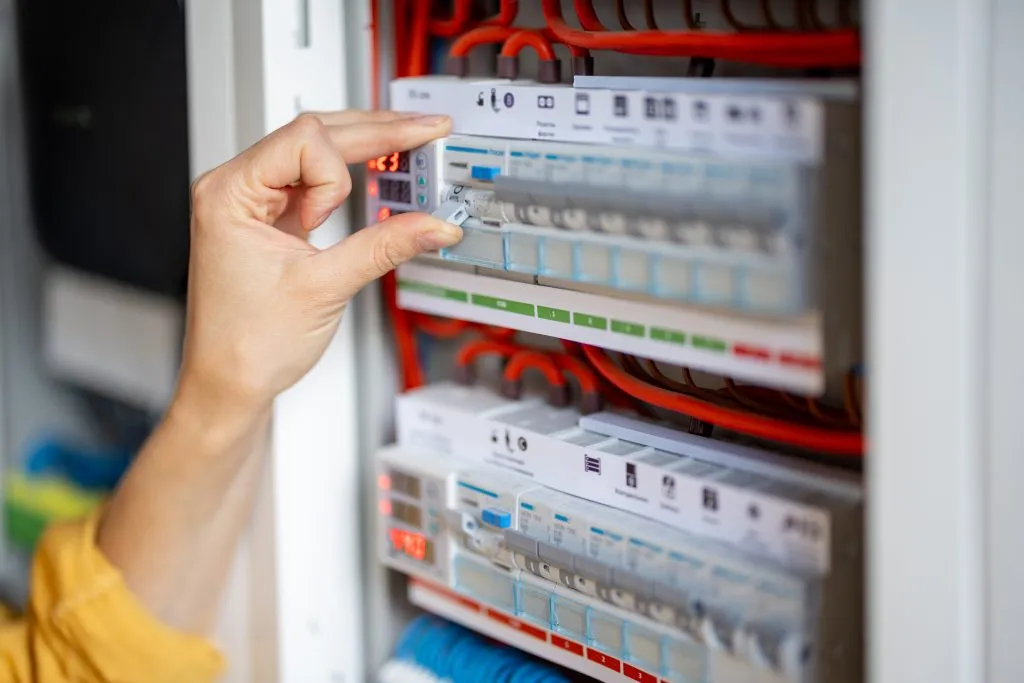 Emergency electrician inspecting an electrical panel